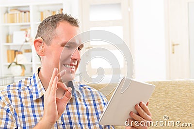 Deaf man using sign language on the tablet Stock Photo