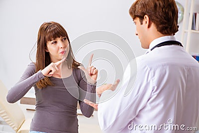 The deaf-mute female patient visiting young male doctor Stock Photo