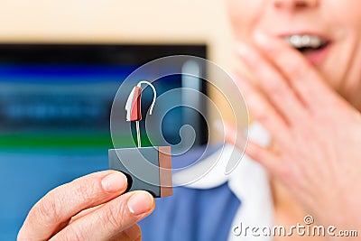 Deaf woman with hearing aid Stock Photo