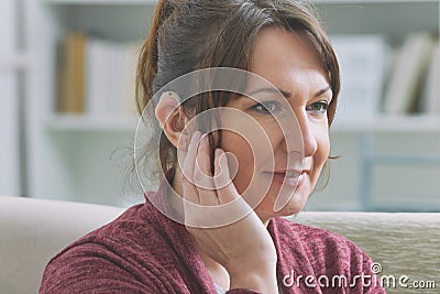 Deaf woman wearing hearing aid Stock Photo