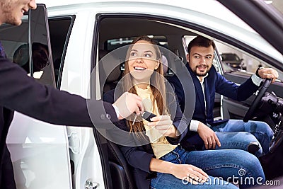 Dealer date keys customer sitting in the car. Car sale Stock Photo