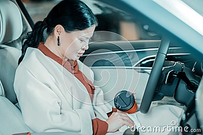 Woman cleaning spilled coffee with a napkin. Stock Photo