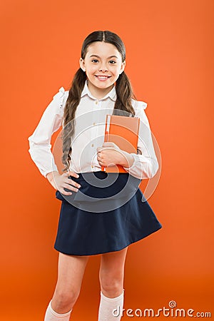 Dealing with school stress. Excellent first former. Girl child hold book. School girl studying textbook. Kid school Stock Photo