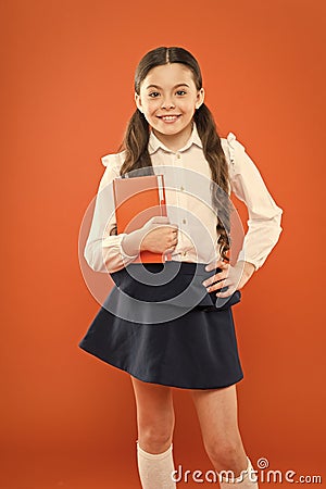 Dealing with school stress. Excellent first former. Girl child hold book. School girl studying textbook. Kid school Stock Photo