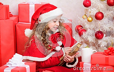 Dear santa. Girl hold pen and paper near christmas tree and gift box. Believe in miracle. Send letter for santa. Wish Stock Photo