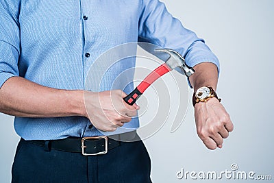 Dear stress, lets break up. Manager cropped view crash wrist watch with hammer. Time break. Time-break. Deadline and Stock Photo