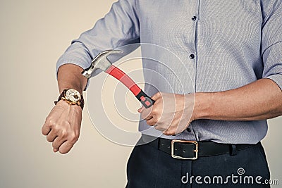 Dear stress, lets break up. Manager cropped view crash wrist watch with hammer. Time break. Time-break. Deadline and Stock Photo