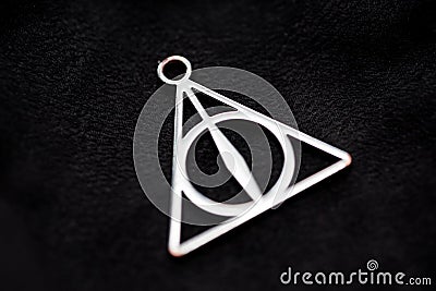 Deathly hallows on black background of fabric texture Stock Photo