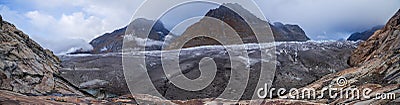 Panoramic photo of the Aletch Glacier in the Swiss Alps. Huge blocks of dirty ice against the backdrop of the mountains Olmenhorn Stock Photo