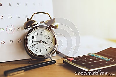 Debt collection and tax season concept with due date on calendar with alarm clock and calculator Stock Photo