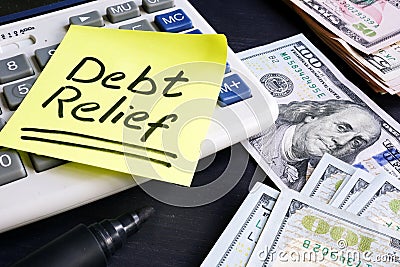 Debt relief handwritten on a note pad. Stock Photo