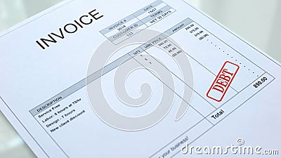 Debt seal stamped on invoice document, business payment, loans and credits Stock Photo