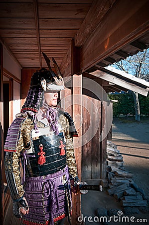 Man in Samurai armor holding Japanese Katana sword Editorial Stock Photo