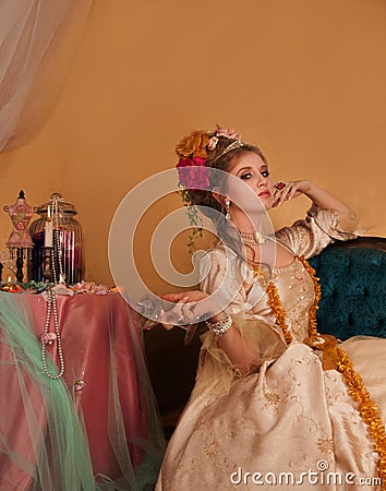 Decadent rococo woman dressed in period fashion holding empty champagne glass Stock Photo