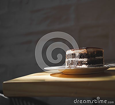 Decadent slice of chocolate cake is artfully presented on a plate, ready to be enjoyed Stock Photo