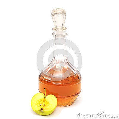 A decanter with apple cider vinegar and half a green apple isolated on a white background. Stock Photo