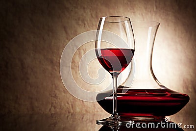 Decanter with red wine and glass on a old stone Stock Photo