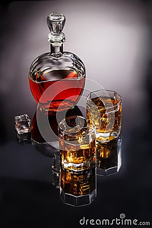 Decanter and two glasses with whisky and ice Stock Photo