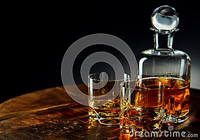 Decanter of whiskey besides two glasses half filled Stock Photo