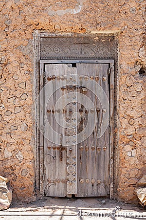 Decayed wooden door with old carvings Editorial Stock Photo