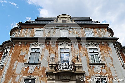 Decaying classicistic town house with typical balcony and windows, located in Esztergom, Hungary. Stock Photo