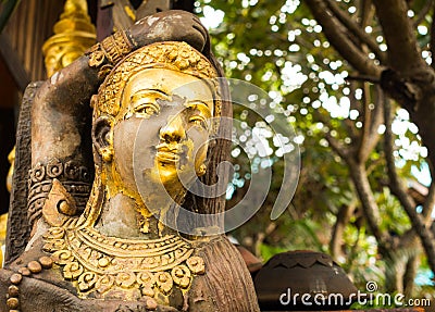 Golden wooden statue in Lamphun Stock Photo