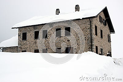 Decaying house, winter in Dolomiti mountains, in Cadore, Italy Stock Photo