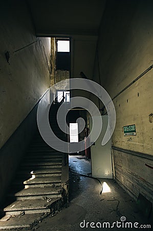 Decaying Stairway: Inside View of Abandoned Industrial Building's Staircase Stock Photo