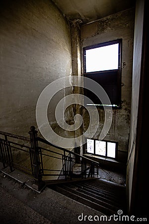 Decaying Stairway: Inside View of Abandoned Industrial Building's Staircase Stock Photo