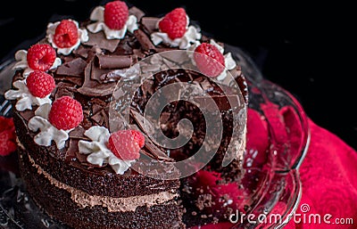 Decedent chocolate cake on a pretty glass cake stand Stock Photo