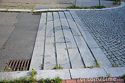Deceleration threshold in the living area from low steps formed by granite curbs which force the vehicle to decelerate Stock Photo