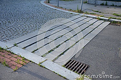 Deceleration threshold in the living area from low steps formed by granite curbs which force the vehicle to decelerate Stock Photo