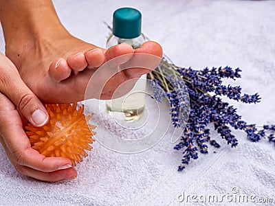 Deceleration Woman massages herself with a massage ball Stock Photo