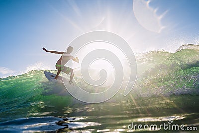 December 30, 2020. Bali, Indonesia. Surfer ride on surfboard at ocean wave. Professional surfing at perfect waves Editorial Stock Photo