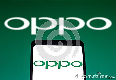 December 14, 2021, Brazil. In this photo illustration the OPPO logo seen displayed on a smartphone and on the background Cartoon Illustration