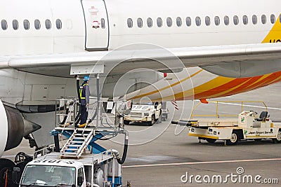 2018 December 14. Chiba Japan. A worker man filling a gassoline into aircarft plane at Narita International Airport. Editorial Stock Photo