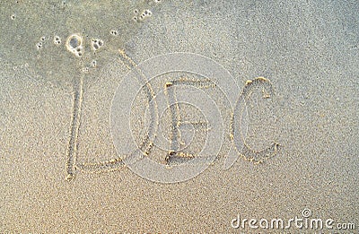 December or Dec word on beach sand. Stock Photo