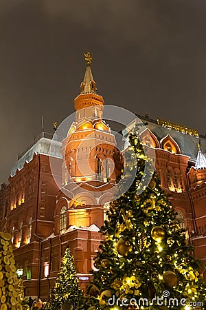 December 21, 2018. Historical Museum on the Red Square of Moscow New Year`s fair, decorated with a bright Christmas tree Editorial Stock Photo