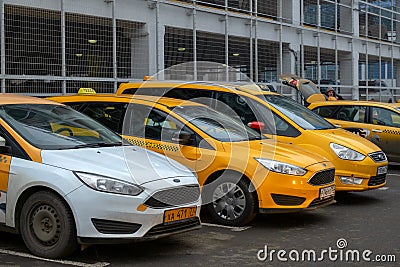 December 13, Moscow, Russia-row of yellow cars Yandex taxi Editorial Stock Photo