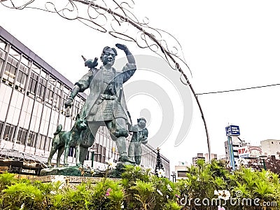 2018 December 06. Okayama Japan. A old Momotaro statue sculpture standing front of Okayama train station with rainy sky background Editorial Stock Photo