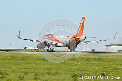 1 December 2022 PORTUGAL, LISBON: EASYJET OE-IJX airplane gaining speed on the runway Editorial Stock Photo