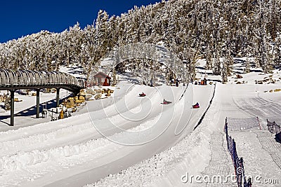 December 26, 2018 South Lake Tahoe / CA / USA - Tourists tubing on the slopes of Heavenly Ski Resort on a sunny winter day Editorial Stock Photo