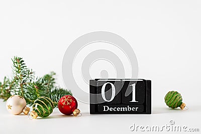 December 1st. Day 1 of december month, calendar with christmas balls decoration and fir branches on white background. Winter time Stock Photo