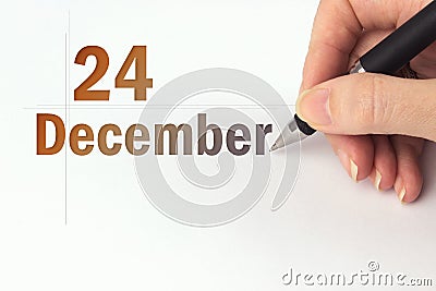 December 24th. Day 24 of month, Calendar date. The hand holds a black pen and writes the calendar date. Winter month, day of the Stock Photo