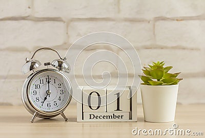 December 1 on the wooden calendar next to the alarm clock, the first day of the first winter month Stock Photo