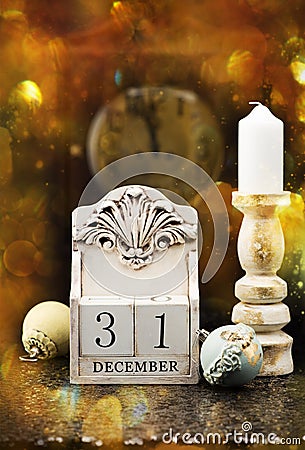 31 December wooden calendar, vintage Christmas balls and antique clock. Stock Photo