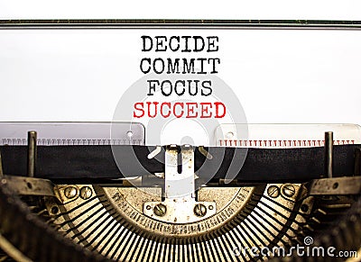 Decide commit focus succeed symbol. Concept word Decide Commit Focus Succeed typed on old retro typewriter. Beautiful white paper Stock Photo