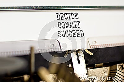 Decide commit succeed symbol. Concept word Decide Commit Succeed typed on beautiful retro old typewriter. Beautiful white paper Stock Photo