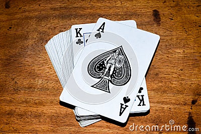 Deck of cards with Ace of spades at front in wooden background. Stock Photo