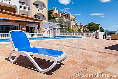 Deck Chair in a Swimming Pool Stock Photo